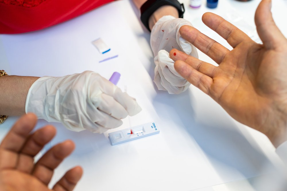 blood test via a prick of the finger conducted by a health professional