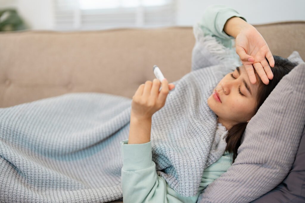 woman having fever lying down