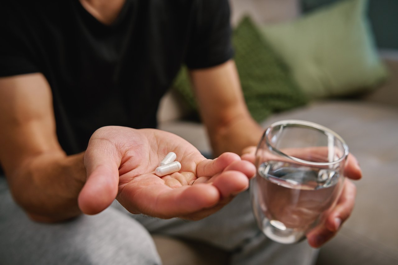 man holding pills oral medication